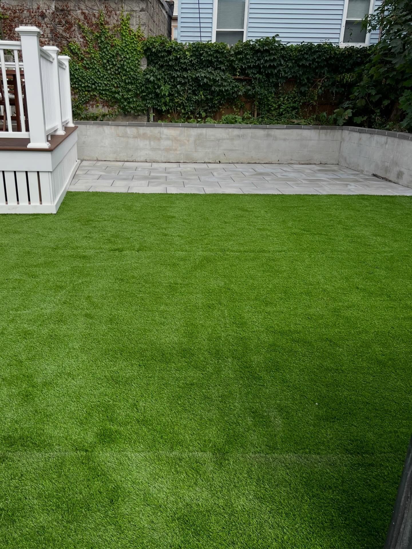 After: Backyard with turf and a new deck
