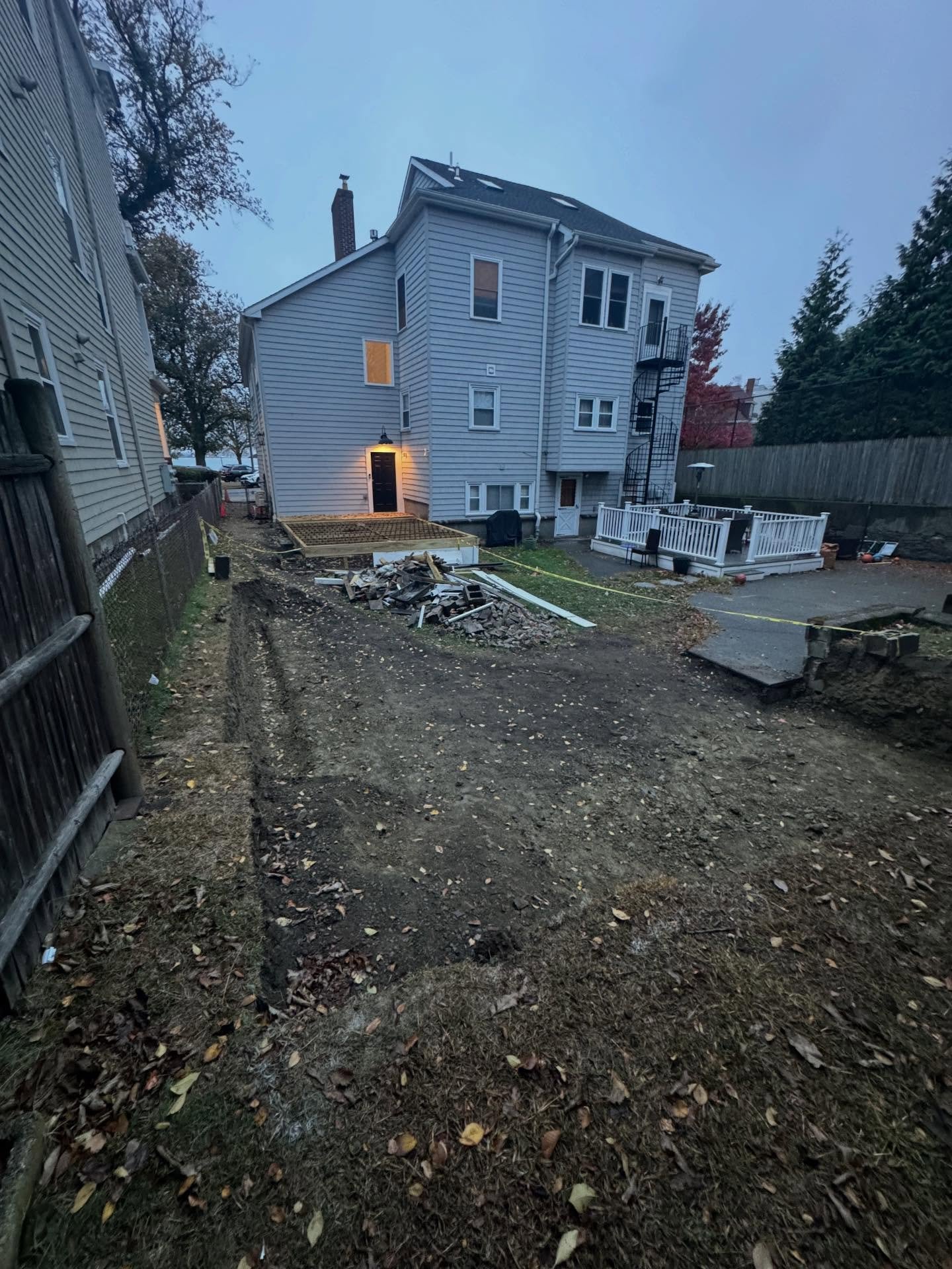 Before: Backyard: pavers, lawn, fence and deck, South Boston