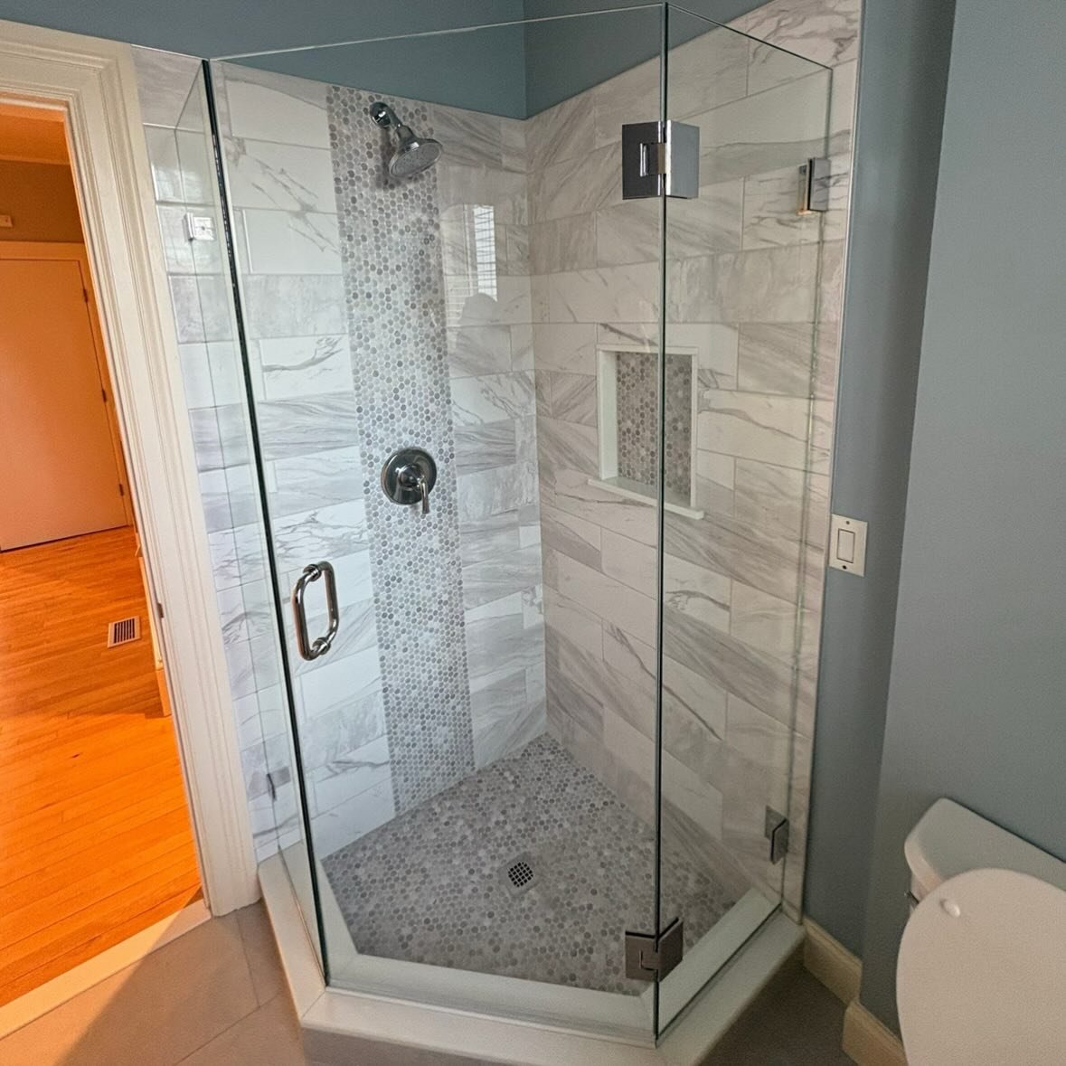 Tile shower with frameless glass in Boston