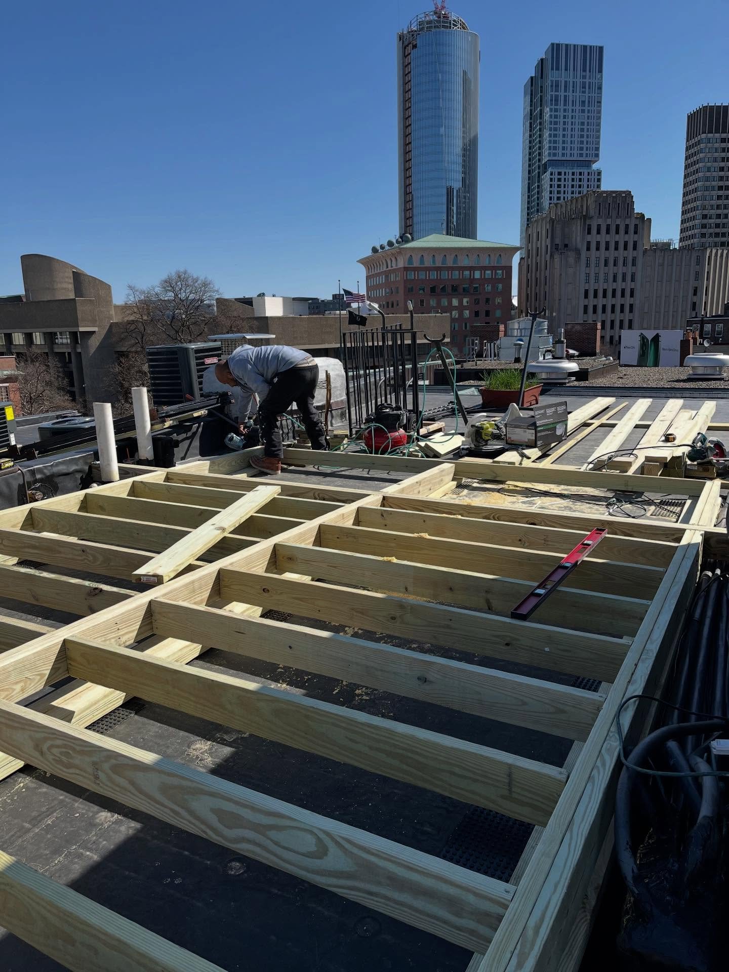RNB General Contracting crew framing a rooftop deck in Boston