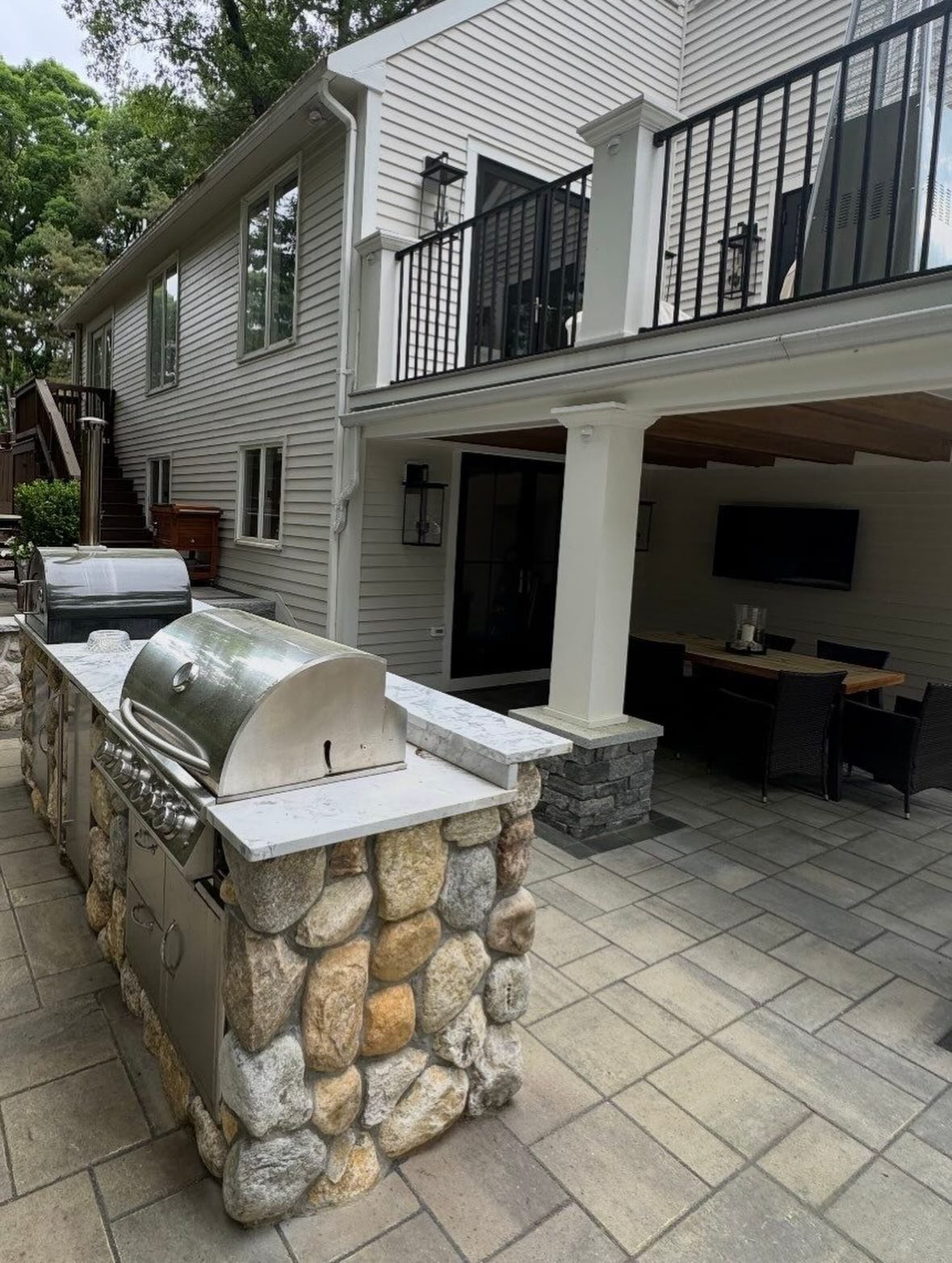Patio with outdoor kitchen and new deck in Boston